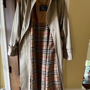 Burberry coat lined in plaid w/ additional zip out plaid. 100% wool. Like new!